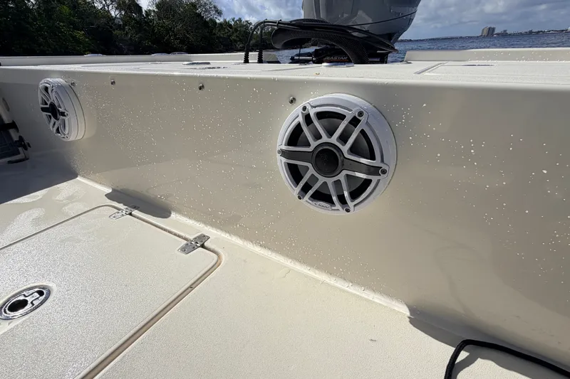 Slide: The Image of 2015 Pathfinder 2200 Tournament Edition boat with speakers, wet deck, and scenic water view. - 30