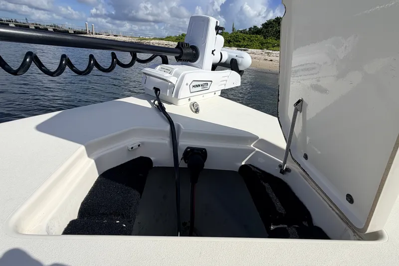 Slide: The Image of 2015 Pathfinder 2200 Tournament Edition boat with open storage compartment and trolling motor. - 40