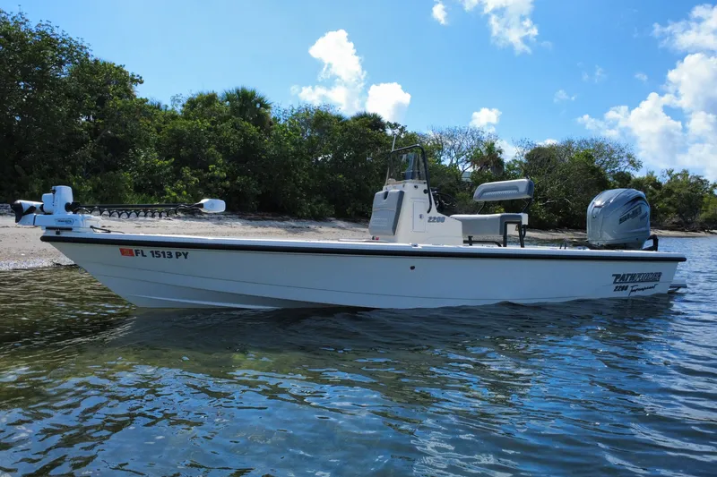 The Image of 2015 Pathfinder 2200 Tournament Edition boat on water near a lush shoreline. - 0