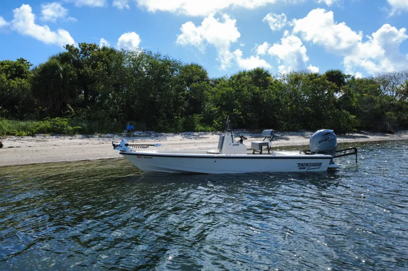 Slide: The Image of 2015 Pathfinder 2200 Tournament Edition boat near a scenic shoreline. - 14