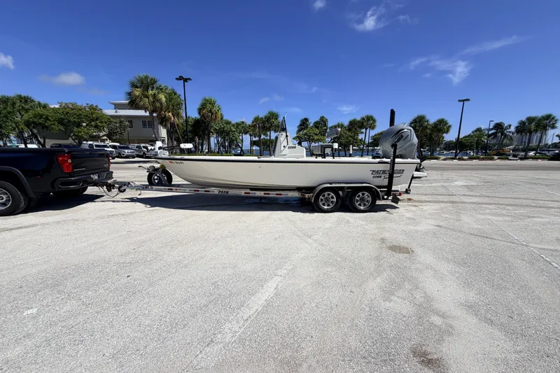 Slide: The Image of 2015 Pathfinder 2200 Tournament Edition boat on trailer in sunny parking lot. - 28
