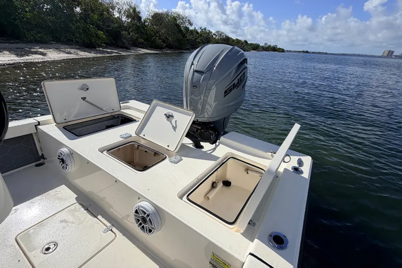 Slide: The Image of 2015 Pathfinder 2200 Tournament Edition boat with open storage compartments by the water. - 35