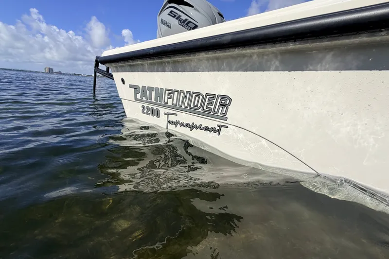 Slide: The Image of 2015 Pathfinder 2200 Tournament Edition boat on calm water, showcasing branding. - 25