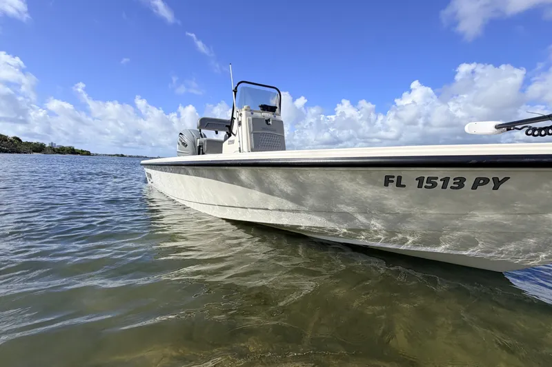 Slide: The Image of 2015 Pathfinder 2200 Tournament Edition boat on calm water under blue sky. - 13