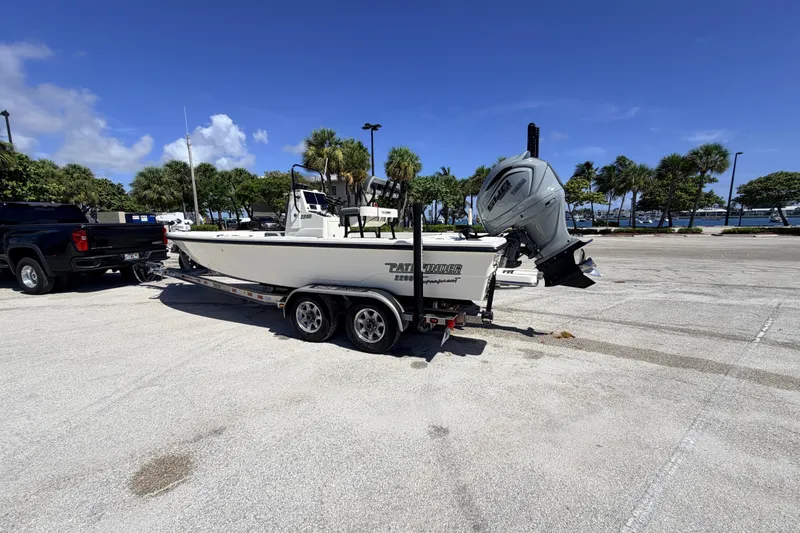 Slide: The Image of 2015 Pathfinder 2200 Tournament Edition boat on trailer in sunny parking lot. - 26