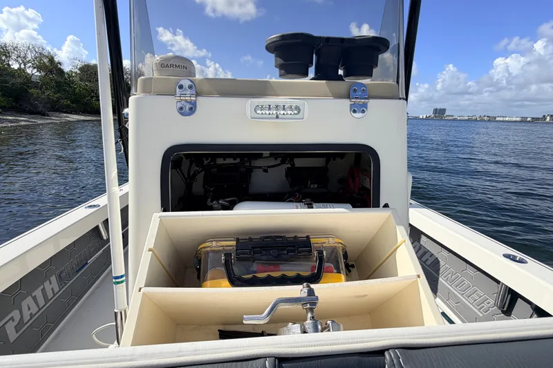 Slide: The Image of 2015 Pathfinder 2200 Tournament Edition boat with storage compartments on a sunny day. - 47