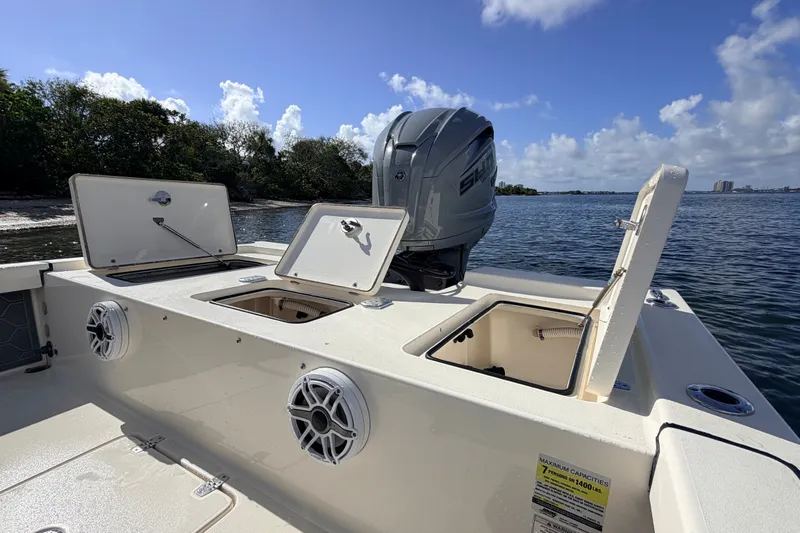 Slide: The Image of 2015 Pathfinder 2200 Tournament Edition boat with open storage compartments and outboard motor. - 37