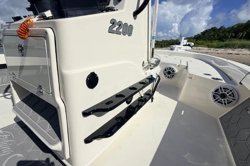 Slide: The Image of 2015 Pathfinder 2200 Tournament Edition boat interior with rod holders and speakers. - 34
