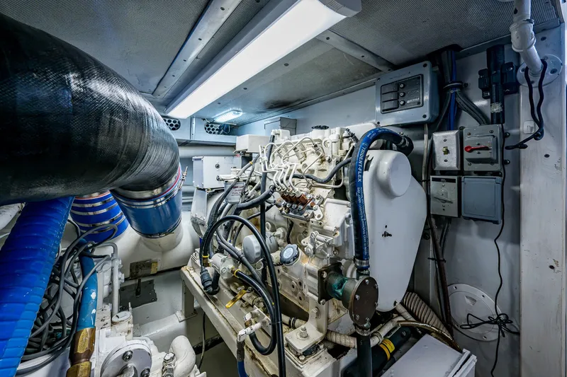 Slide: The Image of Engine room of 1998 Buddy Davis 58 Sportfisherman, showcasing mechanical components and wiring. - 32