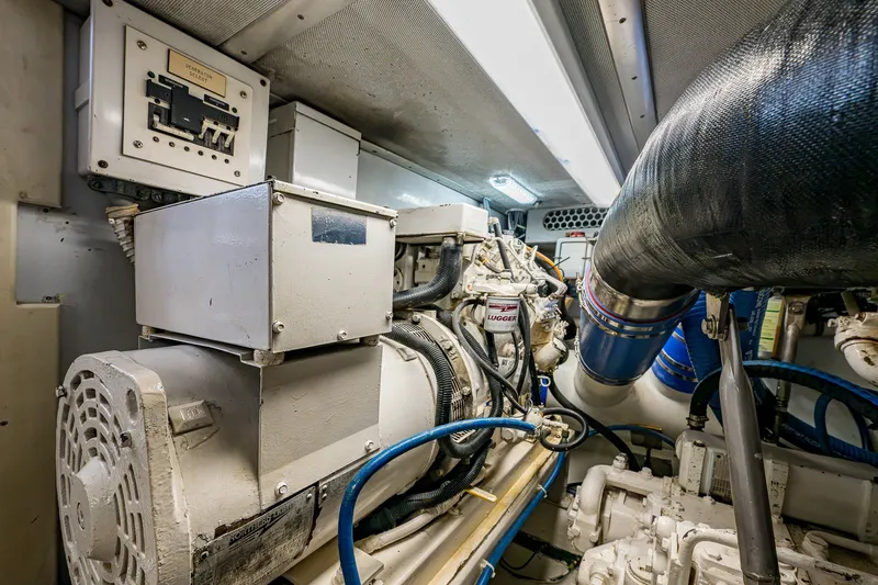 Slide: The Image of Engine room of 1998 Buddy Davis 58 Sportfisherman, showcasing mechanical components and wiring. - 31