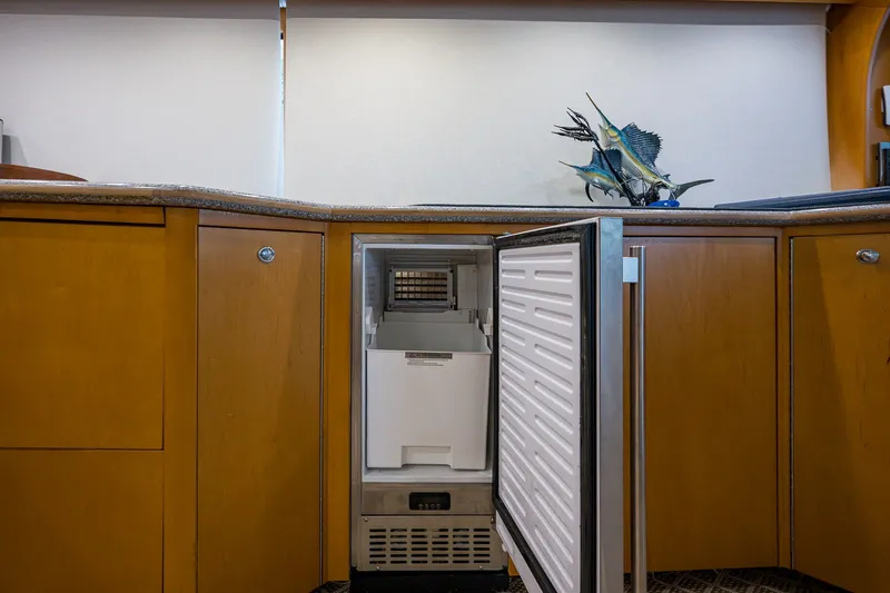 Slide: The Image of Open freezer in 1998 Buddy Davis 58 Sportfisherman yacht kitchen with wooden cabinets. - 18