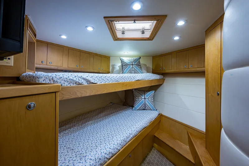 Slide: The Image of Cozy cabin interior of 1998 Buddy Davis 58 Sportfisherman with bunk beds and wooden cabinetry. - 20