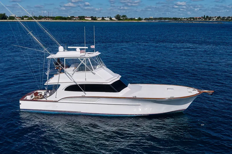The Image of 1998 Buddy Davis 58 Sportfisherman yacht cruising on open blue water. - 1