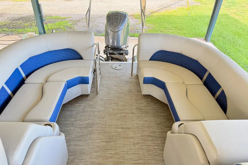 Slide: The Image of 2024 Bennington L22 pontoon boat interior with blue and white seating. - 12