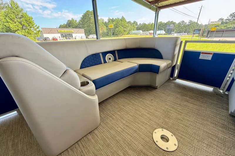 Slide: The Image of 2024 Bennington L22 pontoon boat interior with plush seating and modern design. - 19