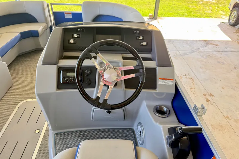 Slide: The Image of 2024 Bennington L22 boat helm with steering wheel and control panel. - 14
