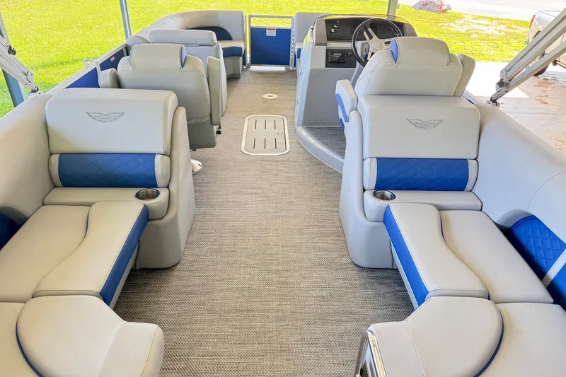 Slide: The Image of 2024 Bennington L22 pontoon boat interior with luxurious seating and modern design. - 9