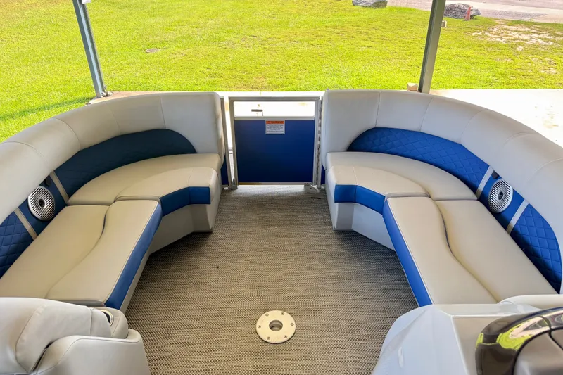 Slide: The Image of 2024 Bennington L22 pontoon boat interior with plush seating and modern design. - 18