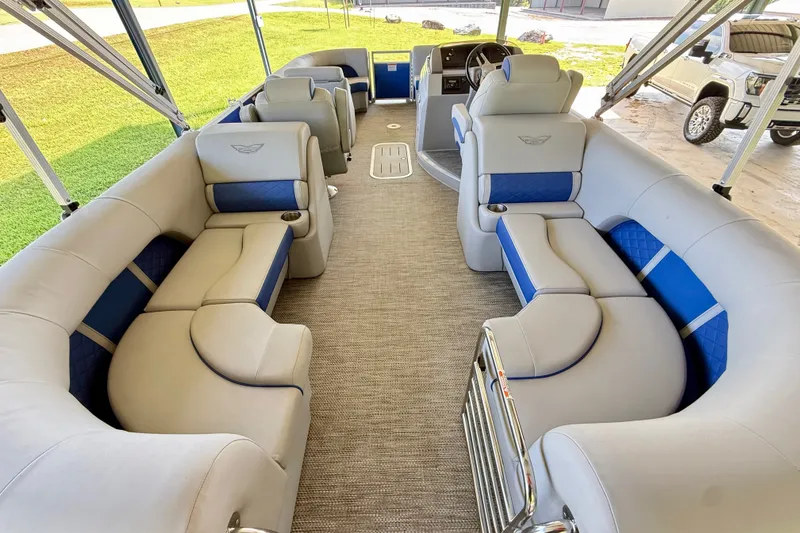 Slide: The Image of 2024 Bennington L22 pontoon boat interior with plush seating and modern design. - 8