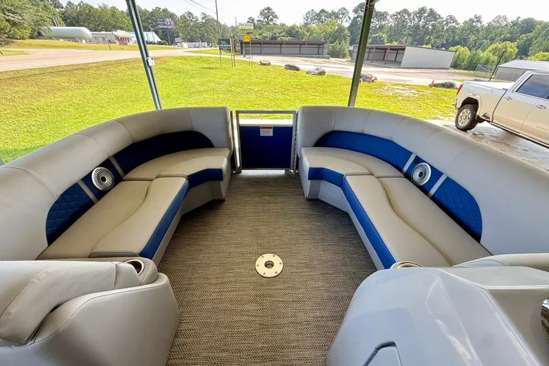 Slide: The Image of 2024 Bennington L22 pontoon boat interior with plush seating and modern design. - 17