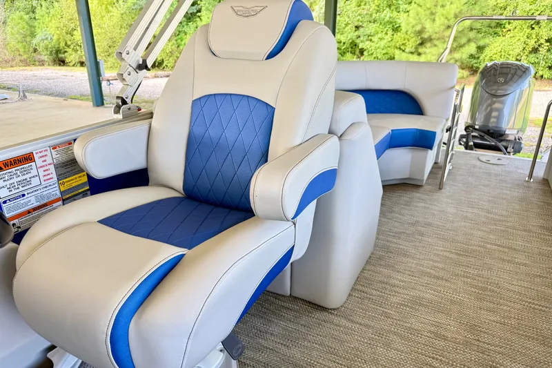 Slide: The Image of 2024 Bennington L22 boat interior with blue and white seating, showcasing luxury design. - 13