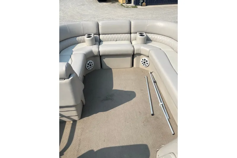 Slide: The Image of 2015 Bennington 22 SLX pontoon boat interior with beige seating and cup holders. - 5