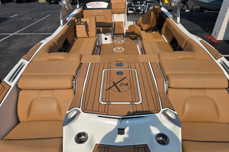 Slide: The Image of 2021 MasterCraft X24 boat interior with tan seating and sleek design. - 4