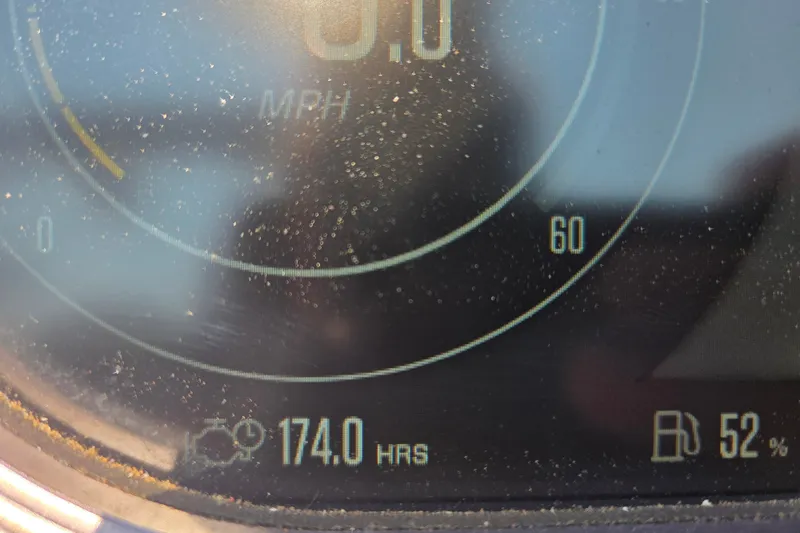 Slide: The Image of Close-up of a 2021 MasterCraft X24 dashboard showing 174 hours and 52% fuel. - 3