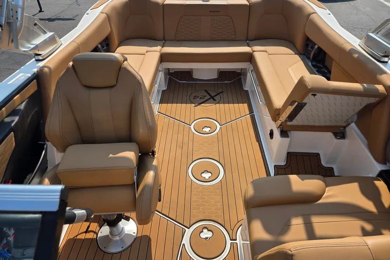 Slide: The Image of Luxurious interior of 2021 MasterCraft X24 boat with tan leather seating and wood flooring. - 6
