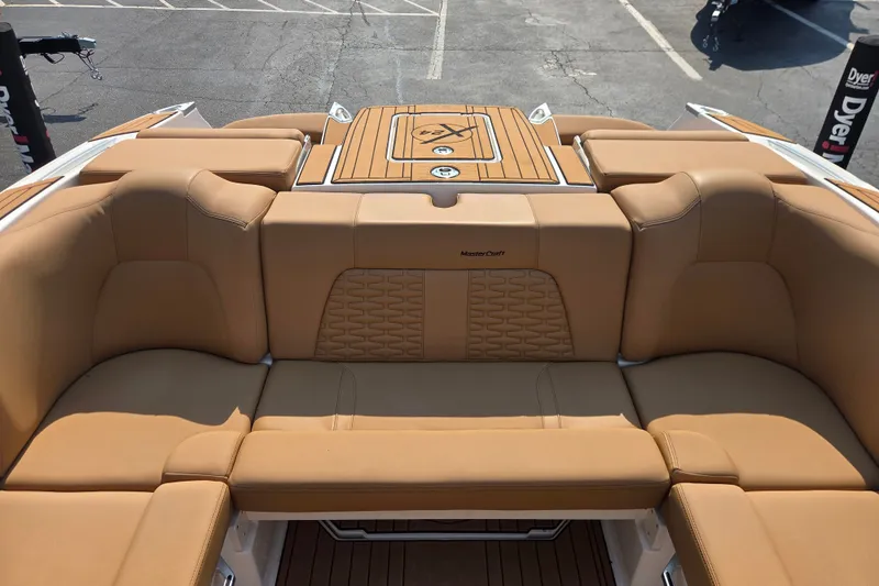 Slide: The Image of 2021 MasterCraft X24 boat interior with tan leather seating and teak accents. - 8