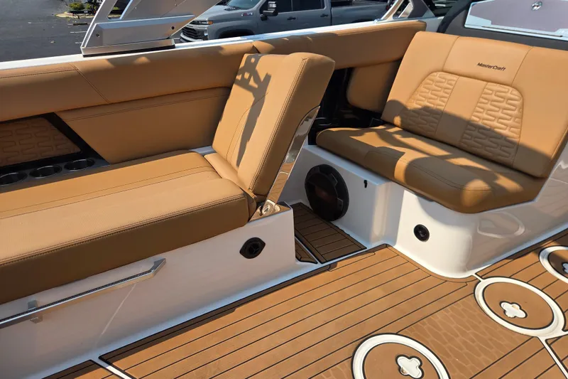 Slide: The Image of 2021 MasterCraft X24 boat interior with tan leather seating and teak-style flooring. - 7