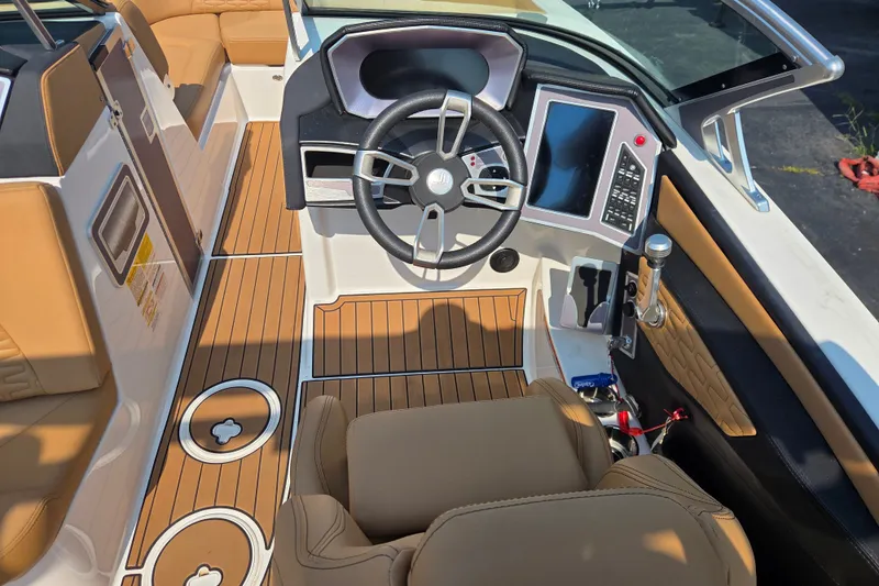 Slide: The Image of 2021 MasterCraft X24 boat interior with modern dashboard and luxurious seating. - 2