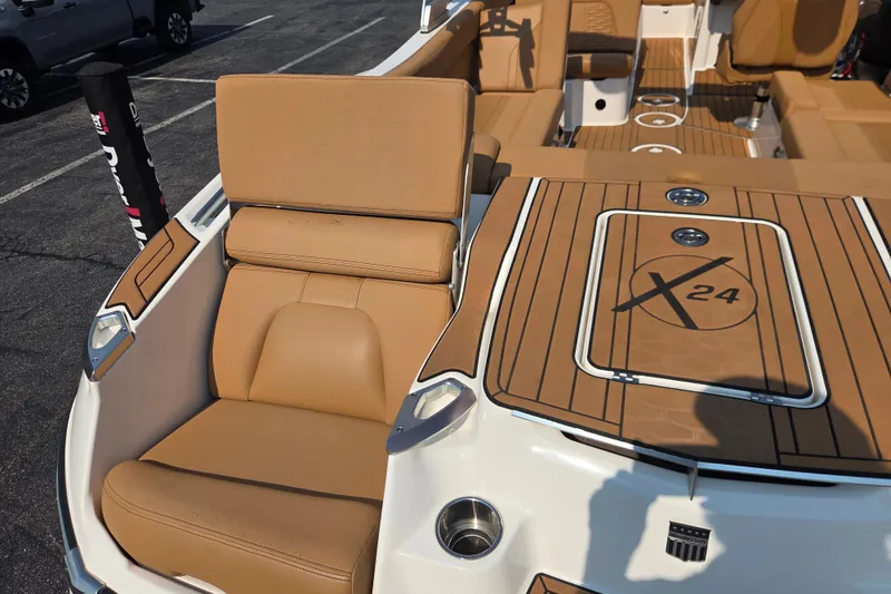 Slide: The Image of 2021 MasterCraft X24 boat interior with tan seating and deck. - 9