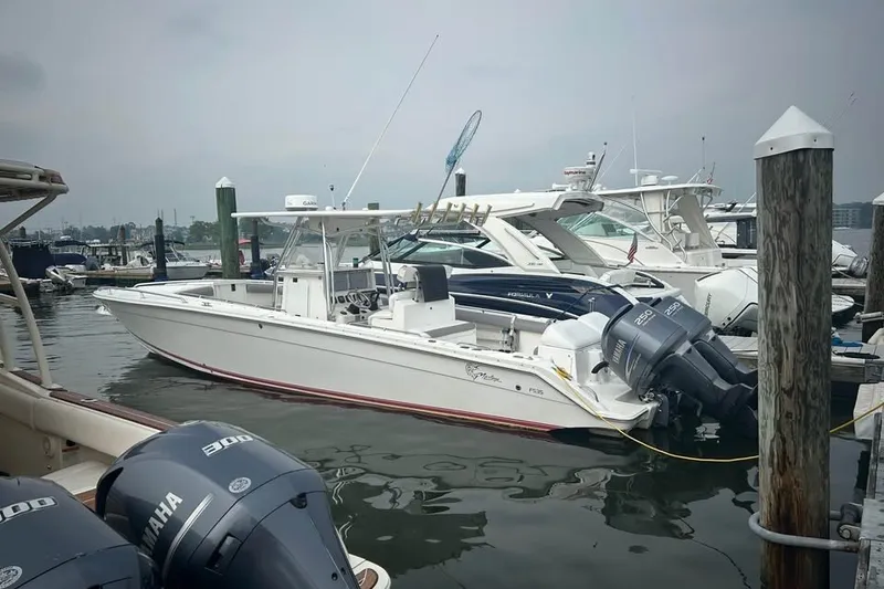 Slide: The Image of 2008 Jefferson Marlago 35 boat docked with Yamaha engines in a marina. - 2