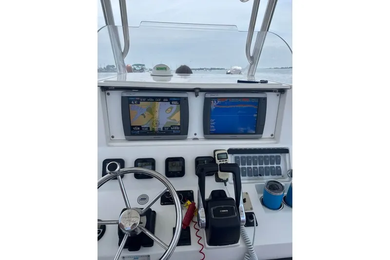 Slide: The Image of Control panel of a 2008 Jefferson Marlago 35 boat with navigation screens and steering wheel. - 9