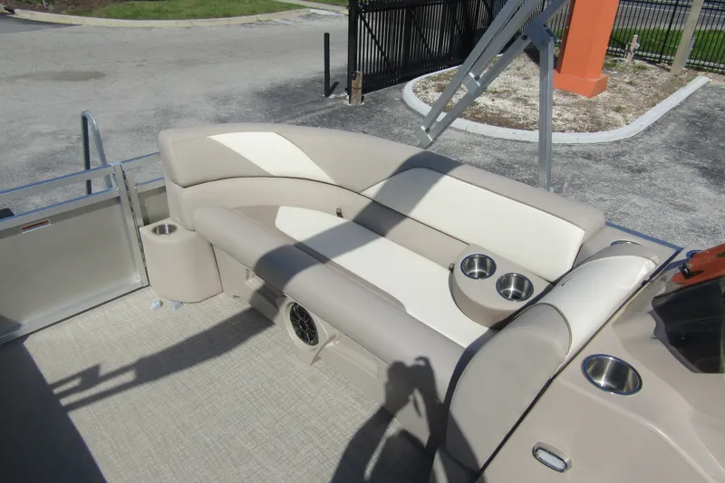 Slide: The Image of 2026 Tahoe Pontoon Sport 85 Rear Fish 21 interior with beige seating and cup holders. - 14