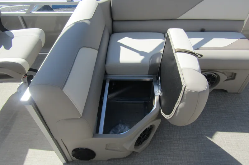 Slide: The Image of 2026 Tahoe Pontoon Sport 85 Rear Fish 21 with open storage compartment on beige seating. - 23