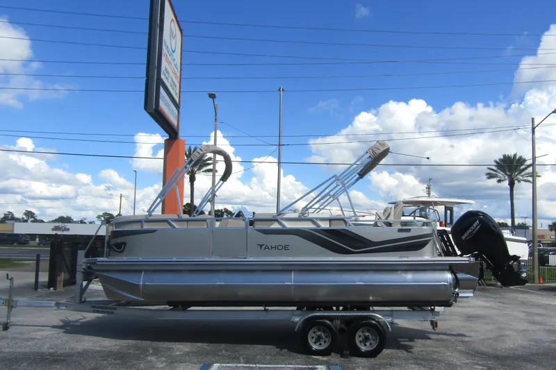 The Image of 2026 Tahoe Pontoon Sport 85 Rear Fish 21 on trailer under blue sky. - 0