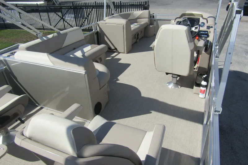 Slide: The Image of 2026 Tahoe Pontoon Sport 85 Rear Fish 21 interior with beige seating and steering console. - 29