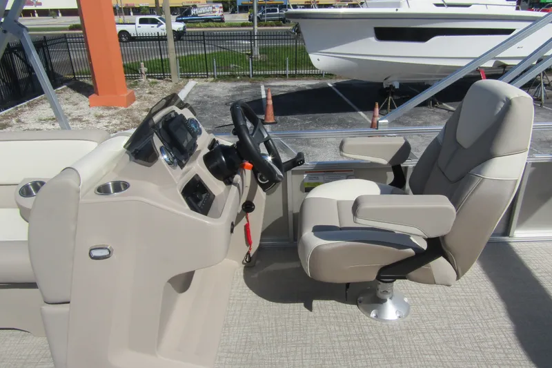 Slide: The Image of 2026 Tahoe Pontoon Sport 85 Rear Fish 21 helm with captain's chair and control panel. - 16