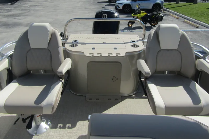 Slide: The Image of 2026 Tahoe Pontoon Sport 85 Rear Fish 21 interior with beige seating and console. - 24
