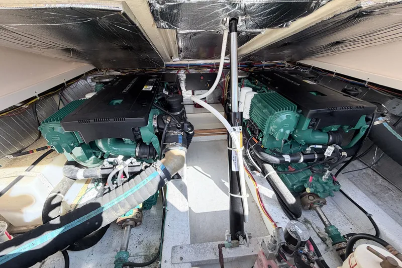 Slide: The Image of Engine compartment of a 2015 Fortier 30 boat, featuring dual marine engines. - 17