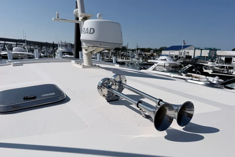 Slide: The Image of 2015 Fortier 30 boat deck with radar and dual trumpet horns at marina. - 16