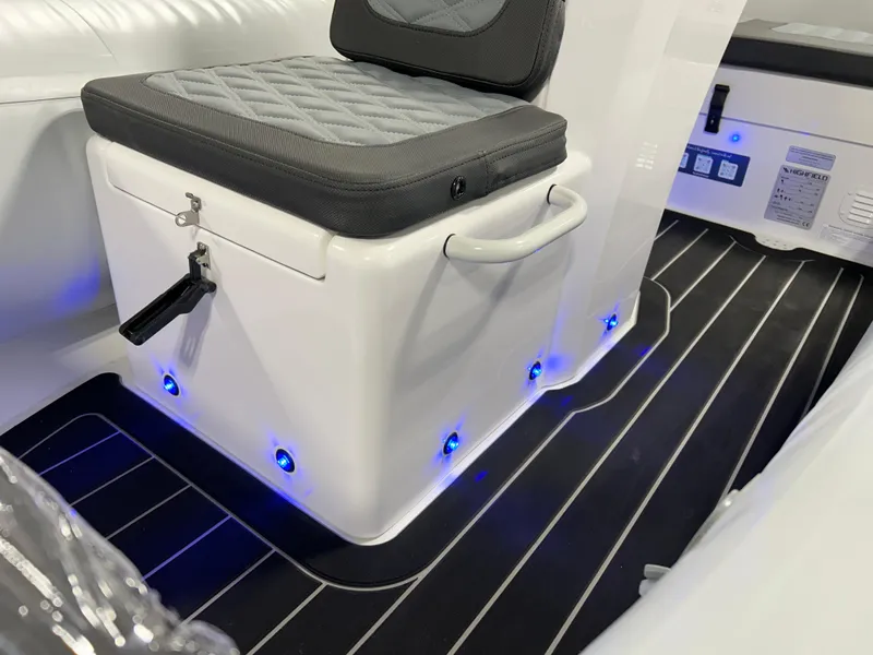 Slide: The Image of Interior of 2025 Highfield Sport 420 boat with cushioned seat and blue LED lights. - 8