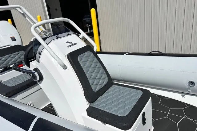 Slide: The Image of 2026 Highfield Sport 420 boat interior with cushioned seating and sleek design. - 13
