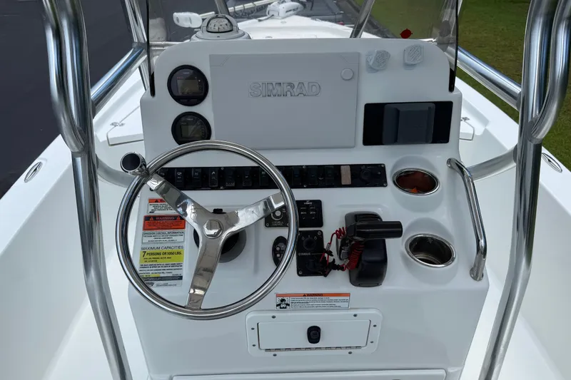 Slide: The Image of 2015 Sea Hunt BX22 Pro boat console with steering wheel and Simrad electronics. - 27