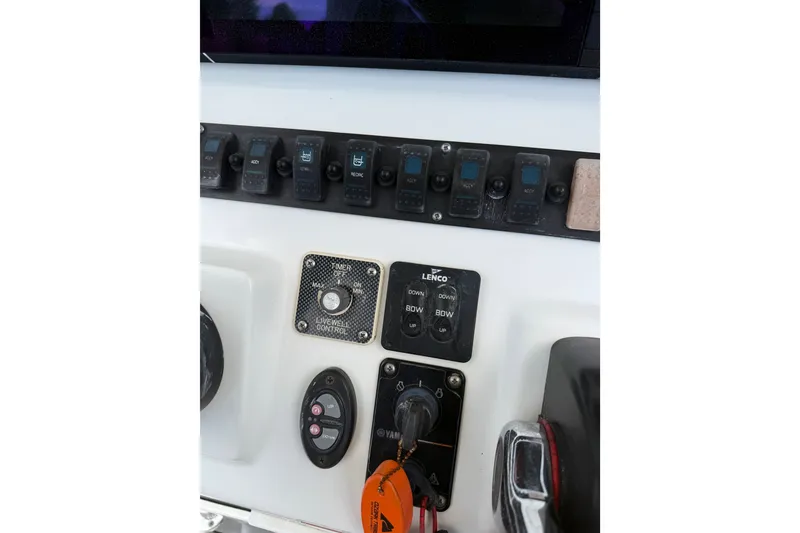 Slide: The Image of Control panel of a 2015 Sea Hunt BX22 Pro boat with switches and controls. - 30