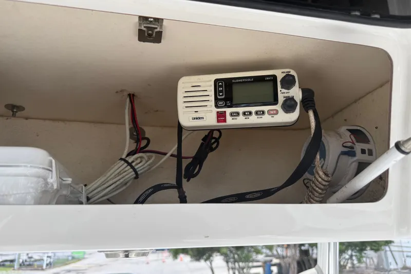 Slide: The Image of 2015 Sea Hunt BX22 Pro boat radio compartment with Uniden marine radio and wiring. - 31