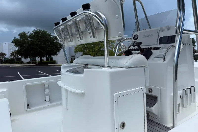 Slide: The Image of 2015 Sea Hunt BX22 Pro boat interior with steering console and rod holders. - 26