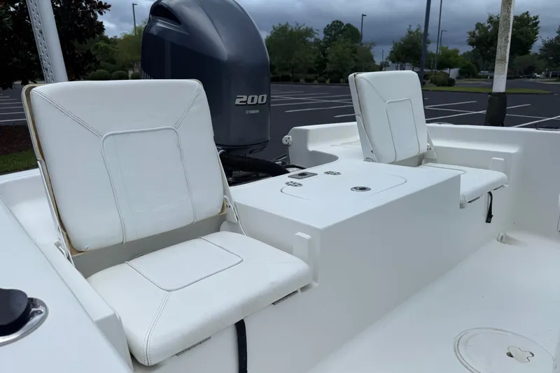 Slide: The Image of 2015 Sea Hunt BX22 Pro boat interior with white seating and Yamaha 200 engine. - 25